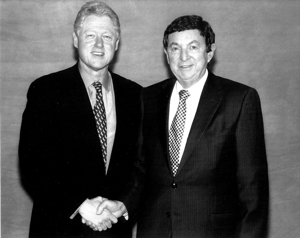 Saul Gilberg shaking hands with President Clinton